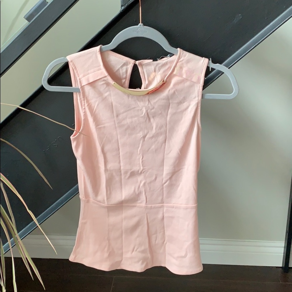 never worn - peach peplum top with tags on